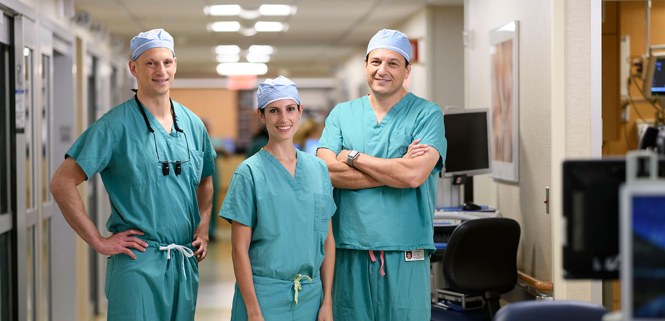 Three MSK Colleagues in green scrubs smiling